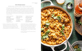 Half Baked Harvest Quick & Cozy cookbook open to cheeseburger pasta recipe with a creamy pasta dish garnished with basil leaves.