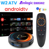 Android TV box with circular black design, LED display, and ergonomic black remote