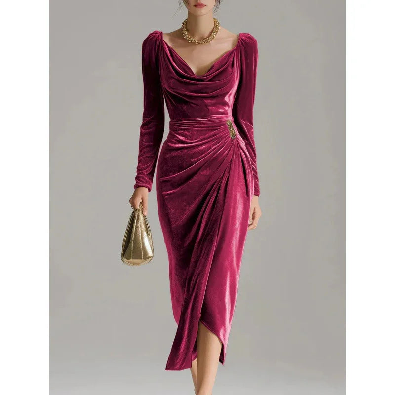 Woman wearing a deep pink velvet midi dress with long sleeves and draped cowl neckline