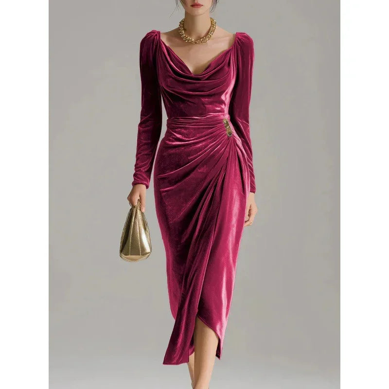 Woman wearing a deep pink velvet midi dress with long sleeves and draped cowl neckline