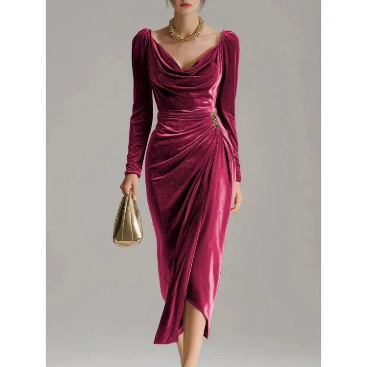 Woman wearing a deep pink velvet midi dress with long sleeves and draped cowl neckline