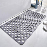 Gray non-slip bath mat with circular holes, modern bathroom setting, rubber material