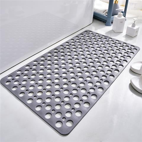 Gray non-slip bath mat with circular holes, modern bathroom setting, rubber material