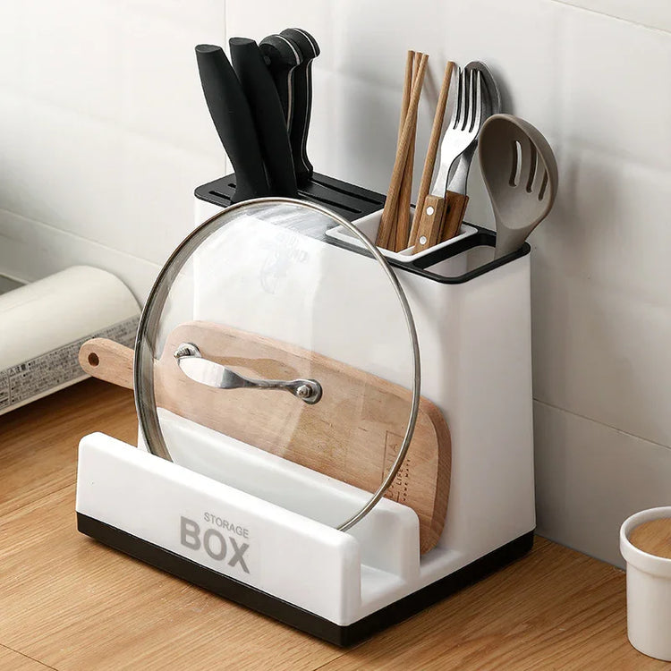 Modern white kitchen utensil holder with knives, chopsticks, spatula, fork, cutting board, and pot lid