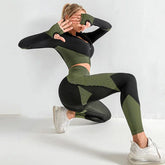Woman wearing textured green and black seamless workout set with fitted crop top and leggings