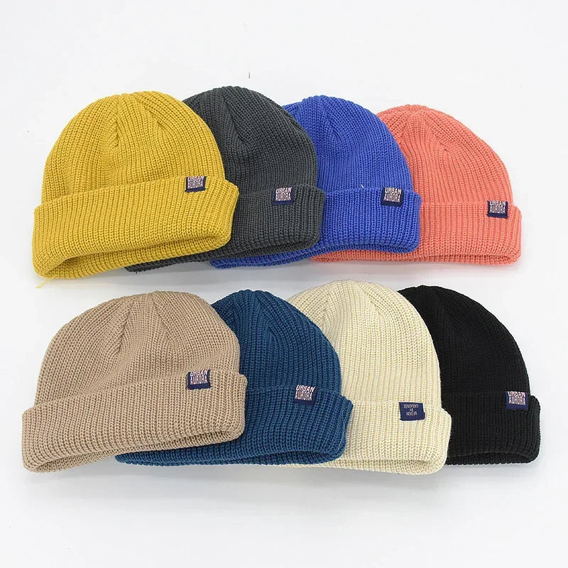 Assorted ribbed knit beanies in yellow, gray, blue, pink, beige, navy, cream, and black