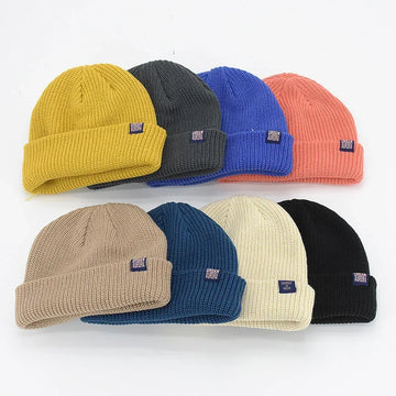 Assorted ribbed knit beanies in yellow, gray, blue, pink, beige, navy, cream, and black