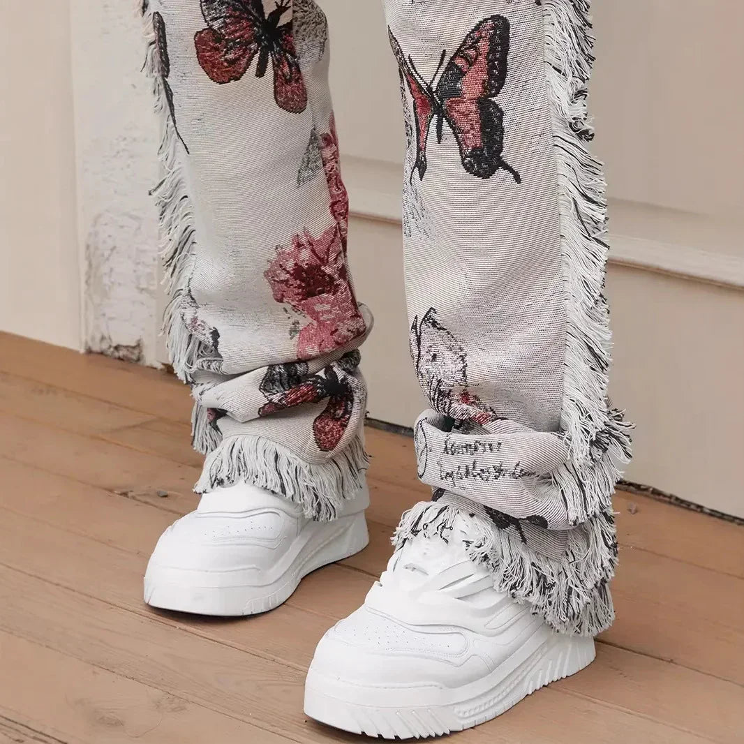Fringe hem straight-leg jeans with butterfly print and loose fit, paired with white sneakers