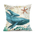 Decorative pillow with blue whale and starfish print on beige, nautical patterned fabric.