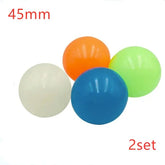 Set of four 45mm bouncy balls in orange, green, blue, and white, glossy finish.