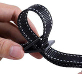 Black nylon webbing belt with white stitching, close-up of adjustable fit
