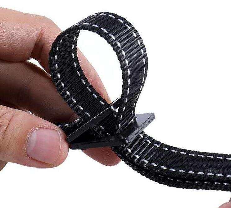 Black nylon webbing belt with white stitching, close-up of adjustable fit