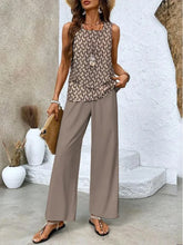 Woman wearing sleeveless geometric print top and wide-leg taupe pants, relaxed fit streetwear