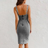 Back view of woman wearing fitted gray denim midi dress with thick straps