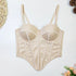 Beige satin corset top with structured boning, molded cups, and adjustable straps, laid flat.