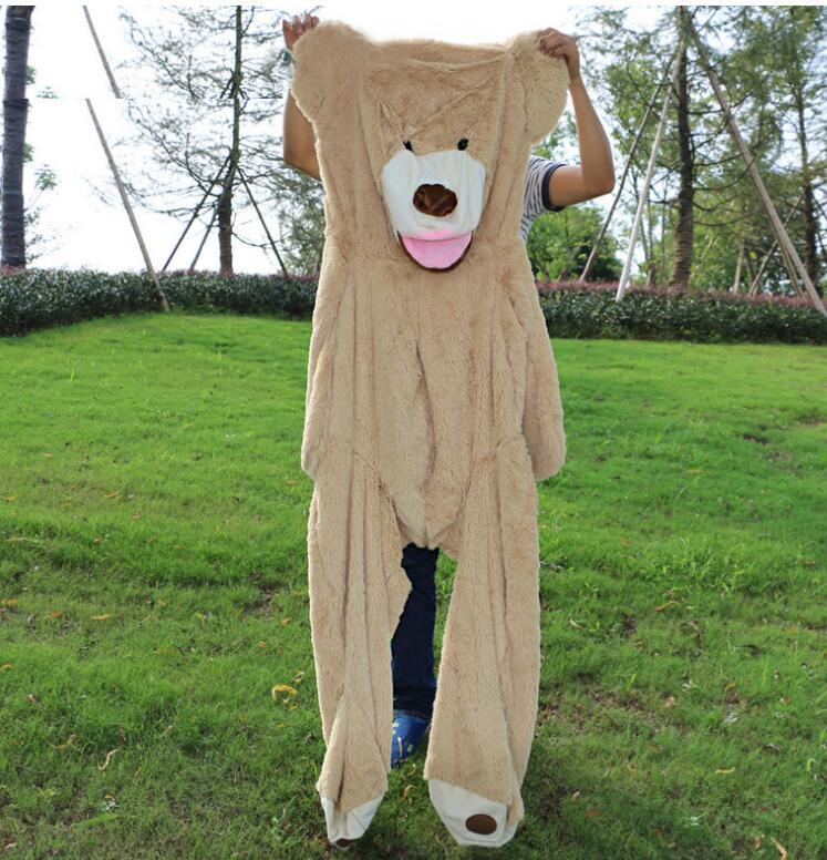 Oversized plush brown bear costume suit, soft faux fur, relaxed fit, shown outdoors on grass.