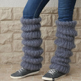 Chunky grey knitted leg warmers with a loose fit, styled over skinny jeans and sneakers.