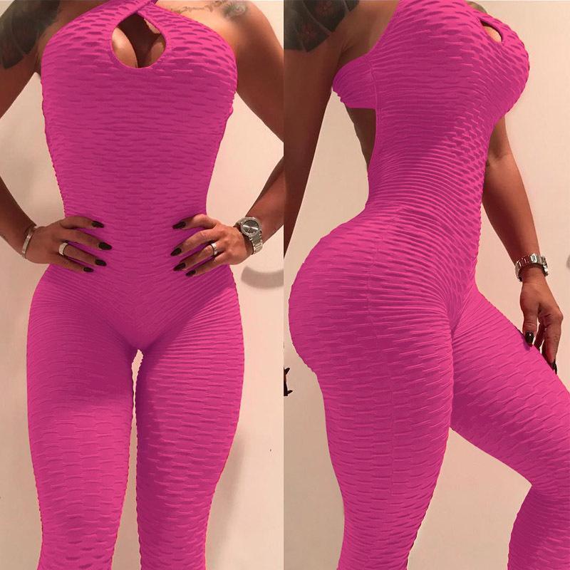 Textured hot pink bodycon jumpsuit with halter neck and cutout detail, form-fitting style