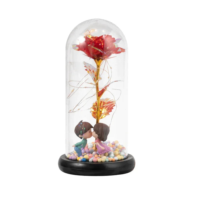 Decorative glass dome with artificial red rose, LED lights, and kissing couple figurines