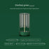 Modern green LED lamp with glass cover, warm yellow light, and cylindrical design