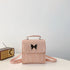 Pastel pink faux leather mini backpack with butterfly accent and adjustable straps, boxy fit