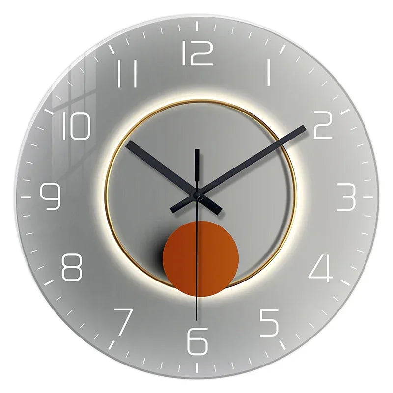 Modern round wall clock with metallic silver finish, bold black hands, and orange accent pendulum.