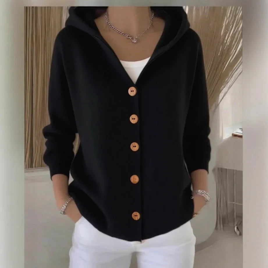 Black hooded cardigan with wooden buttons, relaxed fit, paired with white pants