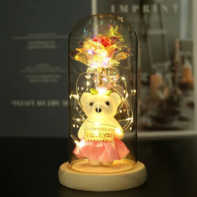 Plush white bear in a pink skirt with LED lights in a glass dome holding I love you sign