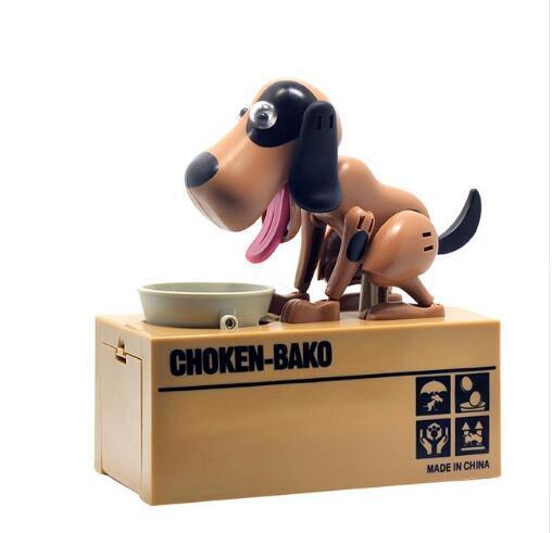 Plastic brown and black dog coin bank toy with moving parts on a beige box