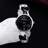 Silver quartz wristwatch with black dial, crystal heart accents, and metal bracelet strap