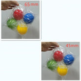 Hand holding sets of red, blue, green, and yellow plastic balls in 65mm and 45mm sizes.