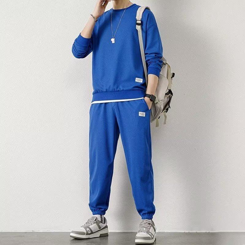 Man wearing a blue streetwear tracksuit set with relaxed fit and ribbed cuffs