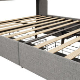 Modern platform bed frame with light wood slats and grey upholstered sides, close-up view