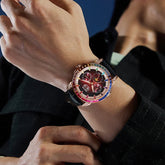 Person wearing a black pinstripe jacket and luxury wristwatch with a multicolor bezel.