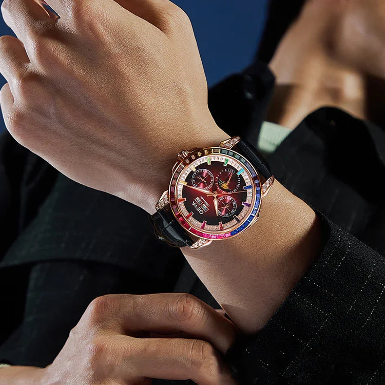 Person wearing a black pinstripe jacket and luxury wristwatch with a multicolor bezel.