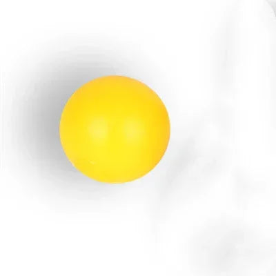 solid yellow rubber ball with matte finish on white background