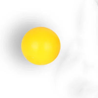 solid yellow rubber ball with matte finish on white background