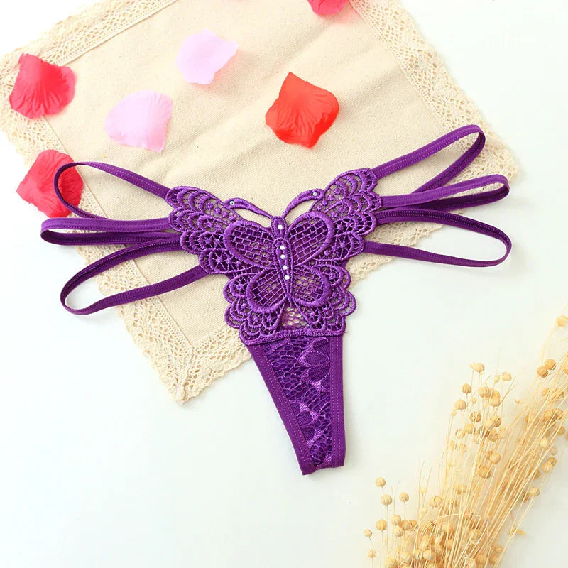 Purple lace butterfly thong with strappy sides and floral lace detailing, laid flat