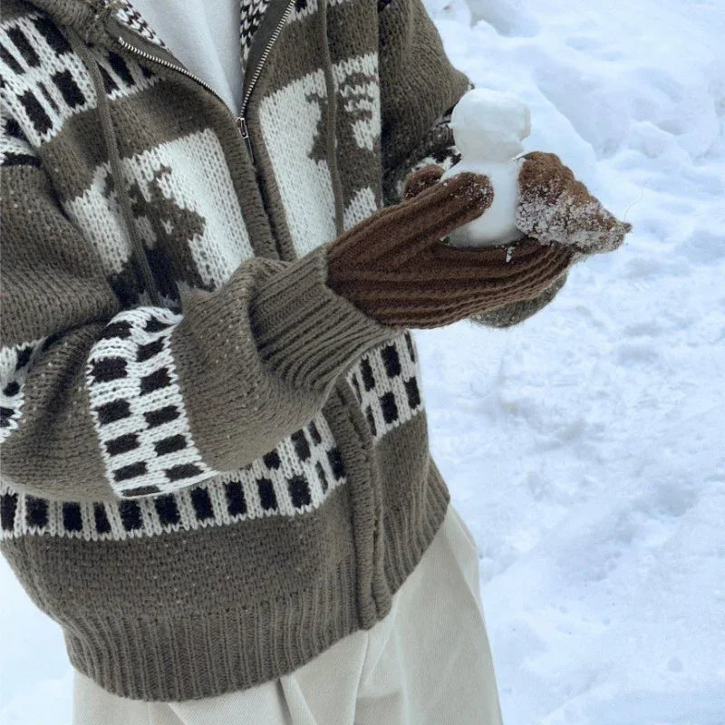 Man wearing a brown patterned knit zip-up sweater and gloves in snow, relaxed fit
