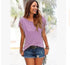 Woman wearing casual lavender fringe sleeve top and distressed denim shorts outdoors