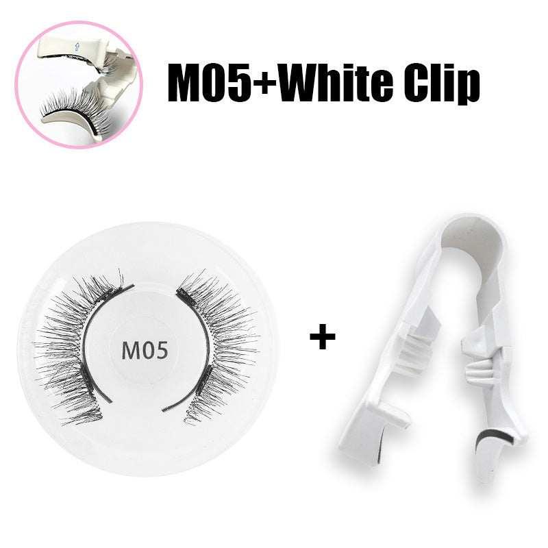Pair of black false eyelashes with white plastic applicator clip on white background