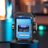 Futuristic blue and black metal gadget with LED lights and exposed circuit components