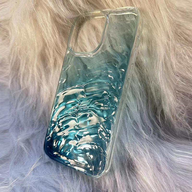Glossy blue textured phone case with wave pattern, clear material, on faux fur background