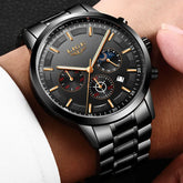 Black stainless steel chronograph watch with gold accents and large dial on wrist