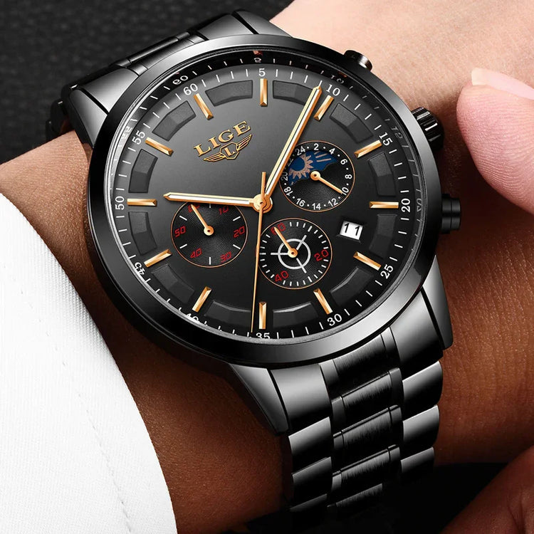 Black stainless steel chronograph watch with gold accents and large dial on wrist