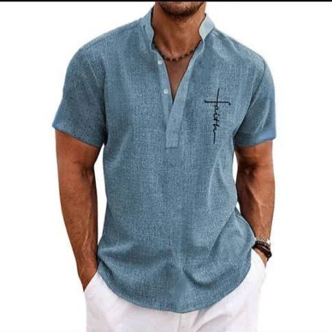 Men’s short sleeve light blue linen shirt with stand collar and relaxed fit, paired with white pants.