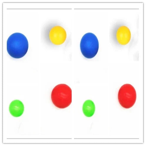 Set of blue, yellow, red, and green round rubber balls on a white background.