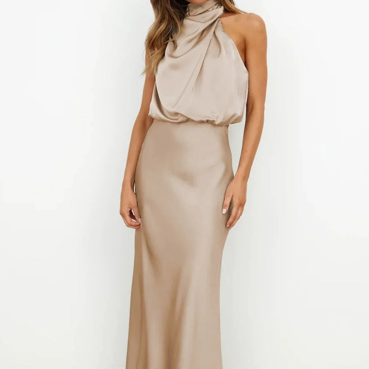 Beige satin halter neck maxi dress with draped bodice and slim fit silhouette.