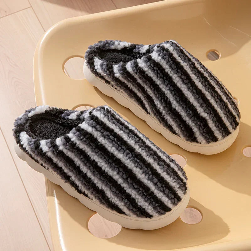 Chunky striped black and white fuzzy slippers with thick sole, cozy indoor slip-on style