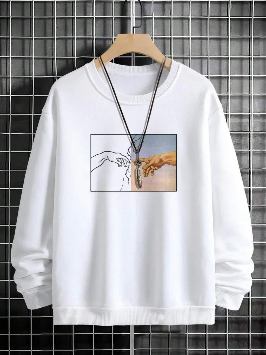White crewneck sweatshirt with artistic graphic print and relaxed fit, displayed on hanger.